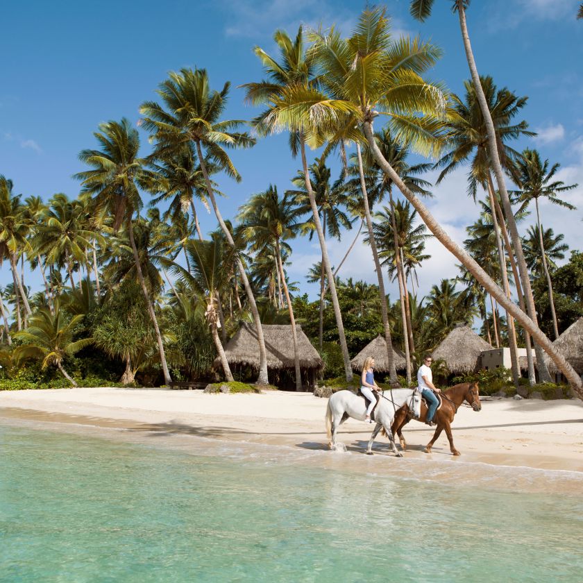 People Riding Horses On A Beach